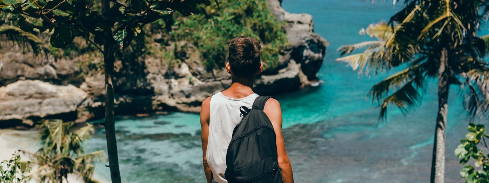 young-guy-with-beard-backpack-posing-jungle-cap-scaled.jpg